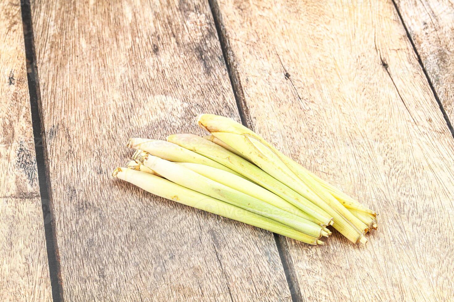 Fresh lemongrass on wooden table photo