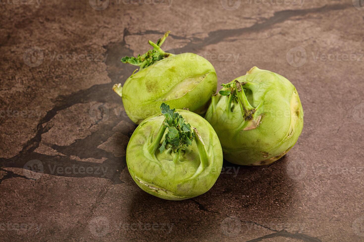 Three green fruits sitting on a table photo
