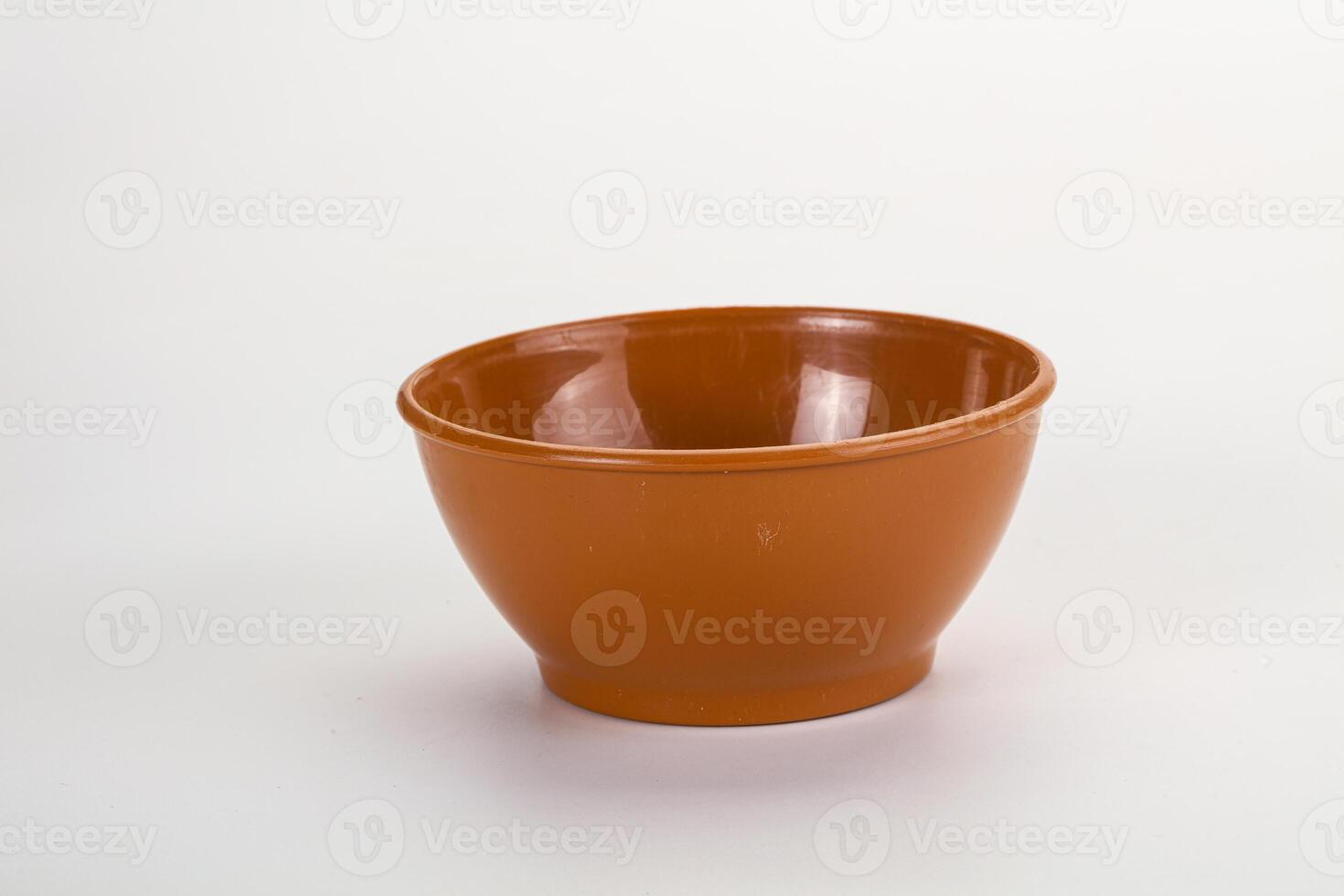 A small brown bowl on a white background photo