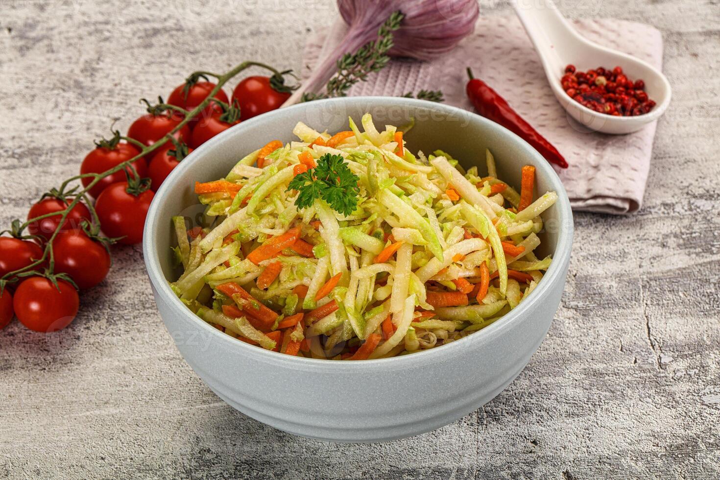 A bowl of salad with carrots and tomatoes photo