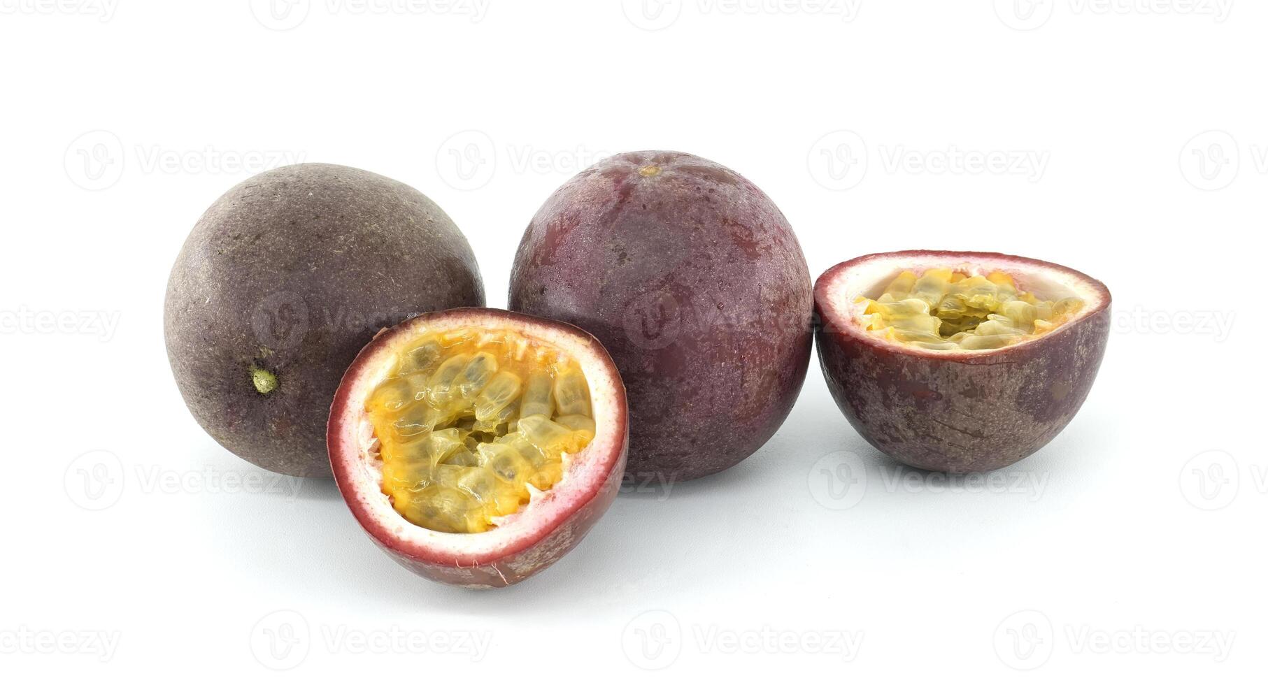 Fresh passion fruits showing pulp and seeds on white background. photo