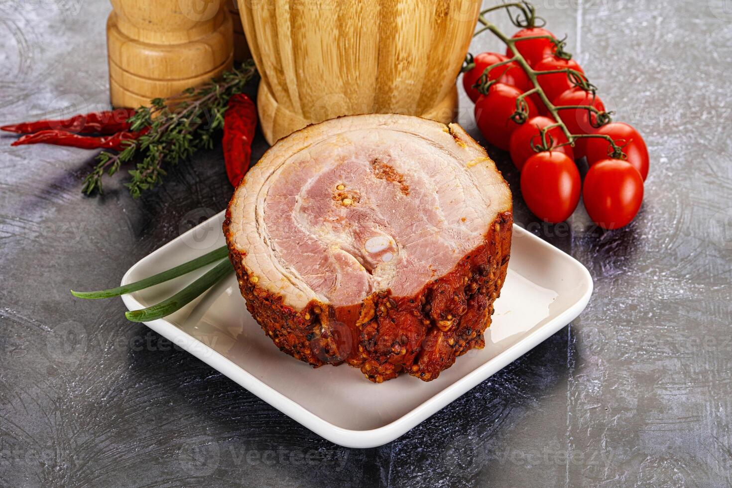A plate with a ham and some vegetables on it photo