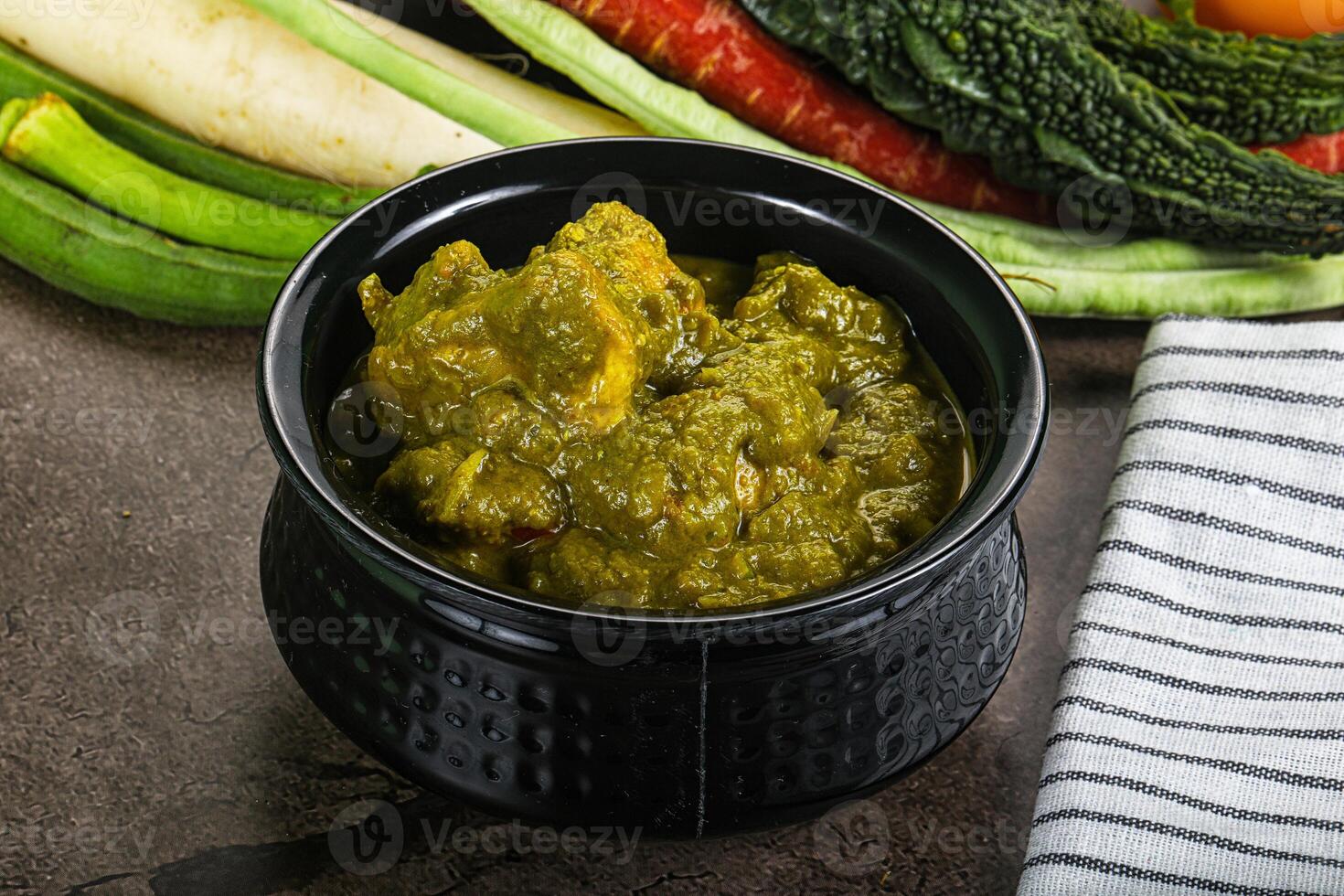 A bowl of food with vegetables and a towel photo