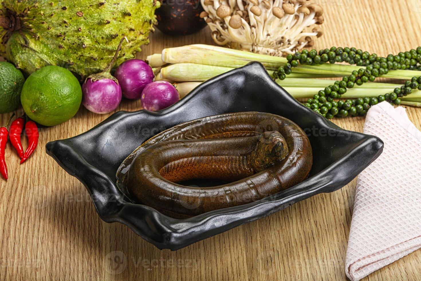 A snake is sitting in a bowl of food photo