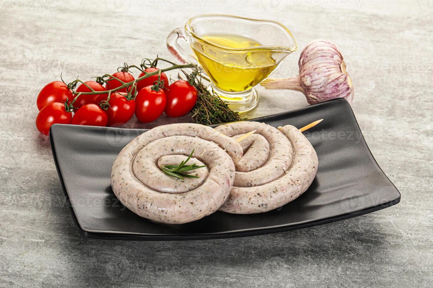 A plate with two sausage rolls and a bottle of olive oil photo