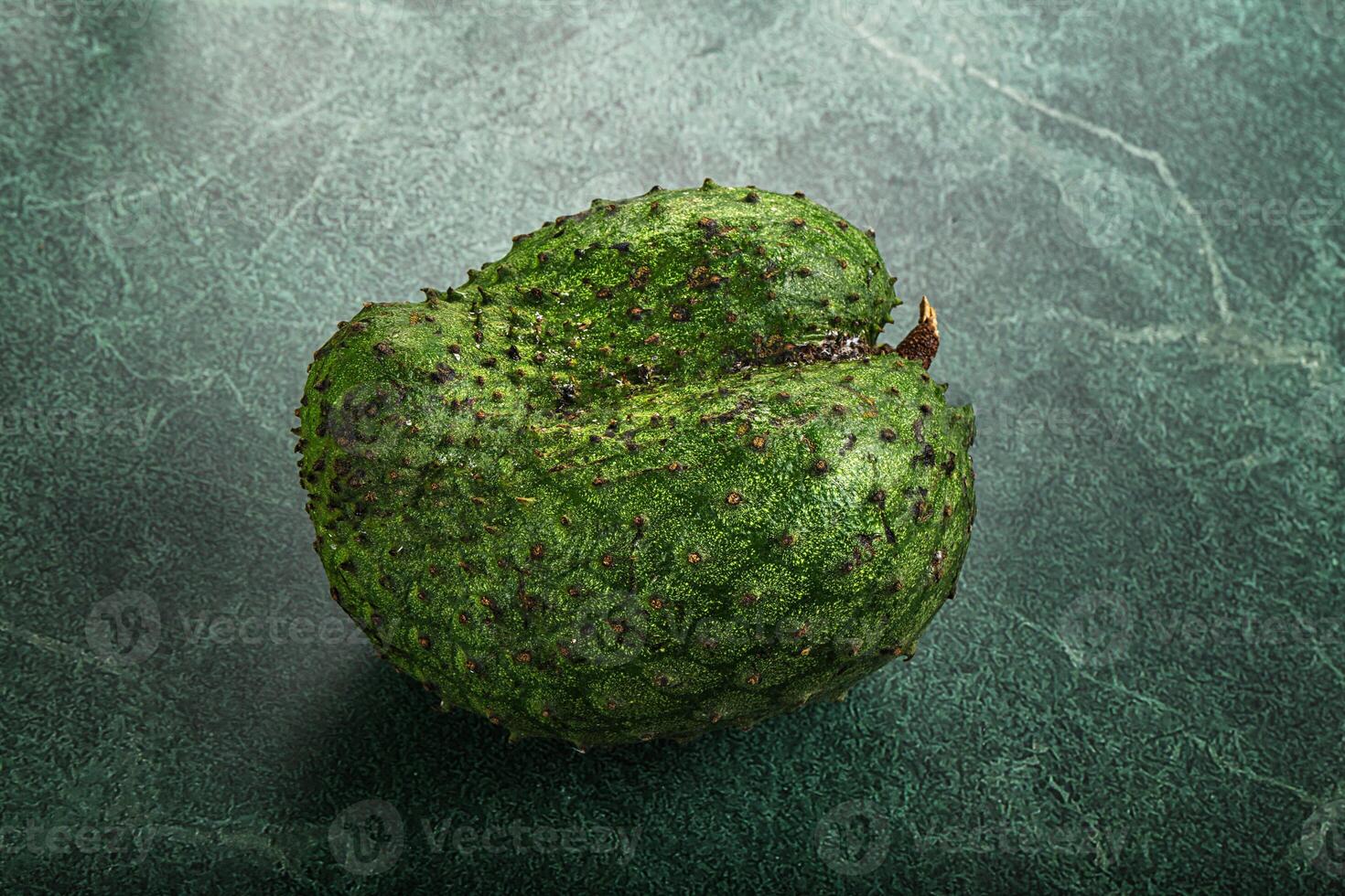 A green fruit on a green background photo