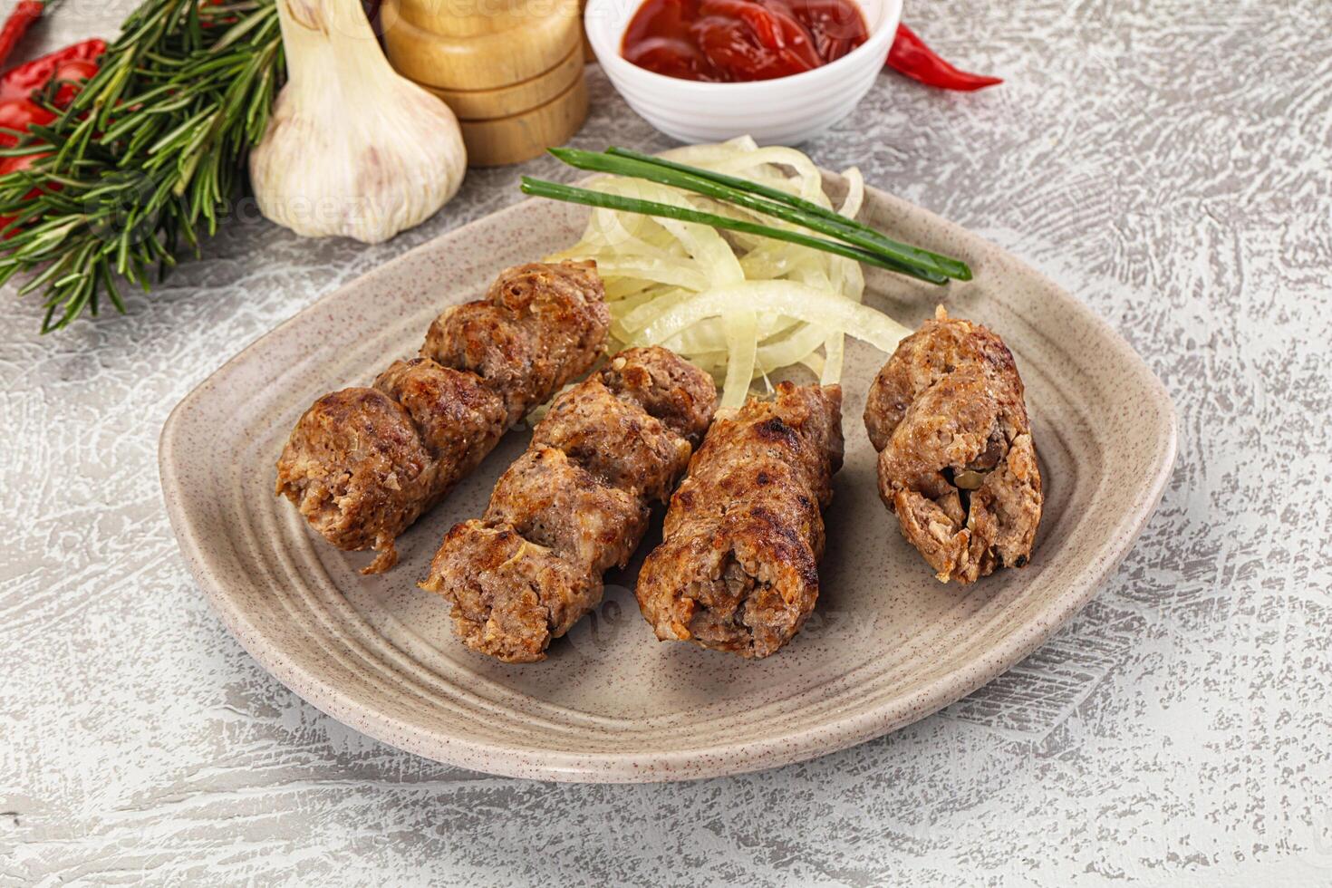 A plate with meat skewers and vegetables photo