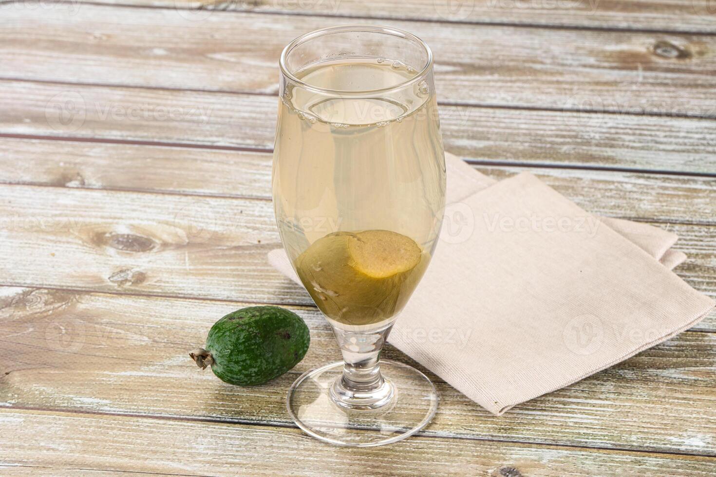 A glass of champagne with an avocado on a napkin photo