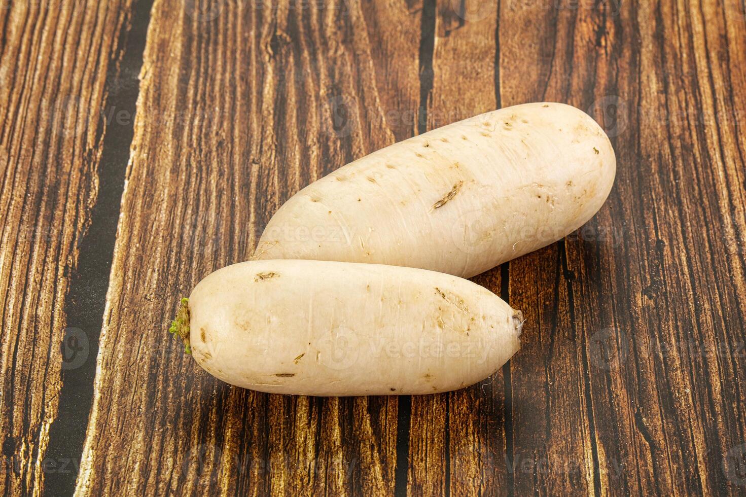Two white potatoes on a wooden table photo