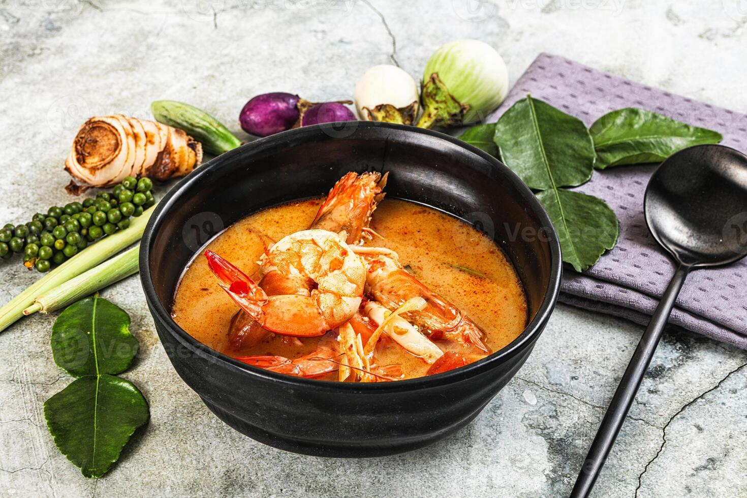 A bowl of soup with shrimp and vegetables photo