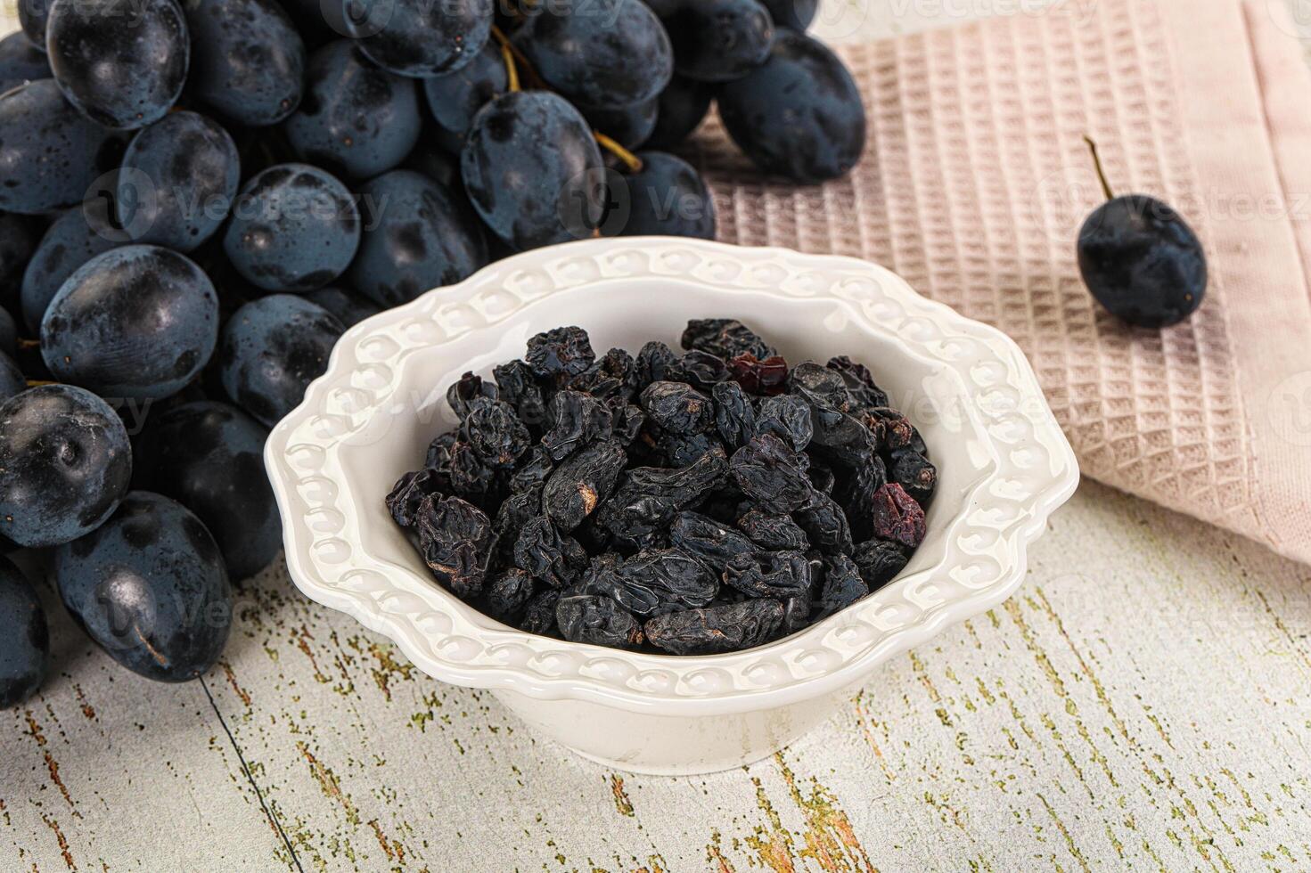 A bowl of black grapes photo