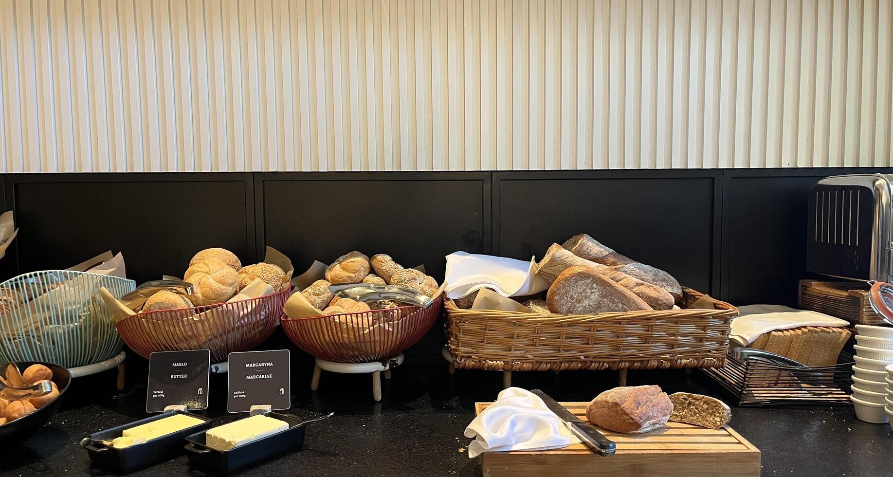 Warsaw, Poland. November 02, 2024. Freshly baked breads and pastries are displayed on a buffet table. There are different types of bread, including rolls, baguettes, and loaves photo