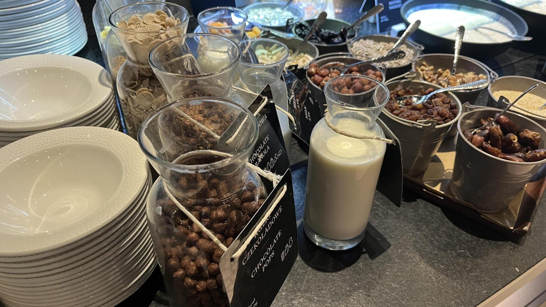 Warsaw, Poland. November 02, 2024. A breakfast buffet table filled with various cereal and topping options. There are glass jars filled with different types of cereal, nuts, and dried fruits photo