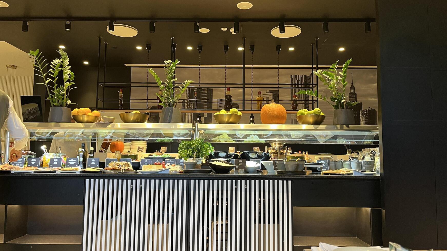 Warsaw, Poland. November 02, 2024. A breakfast buffet spread in a modern, stylish setting. There's a variety of food options, including fresh fruits, pastries, and other dishes. photo