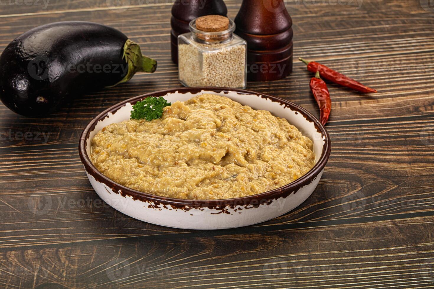 A bowl of food on a table with other ingredients photo