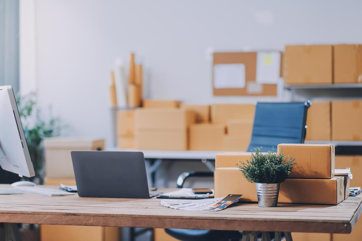 A desk with a laptop and boxes on it photo