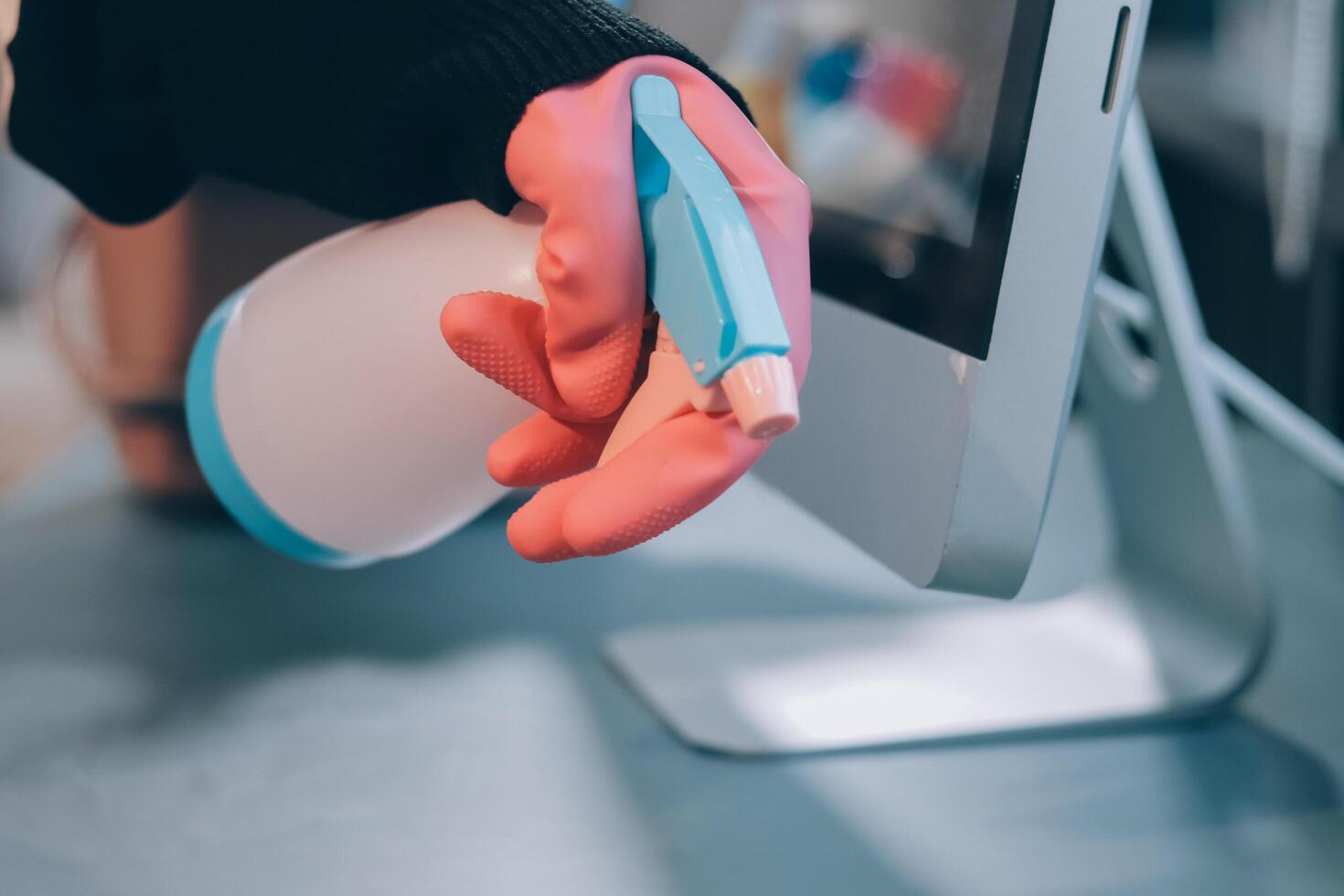 A person in pink gloves is holding a cleaning product photo