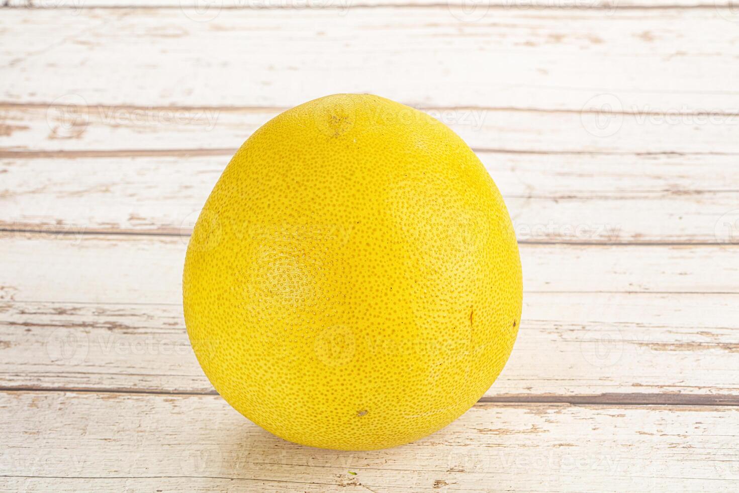 A yellow fruit on a white table photo