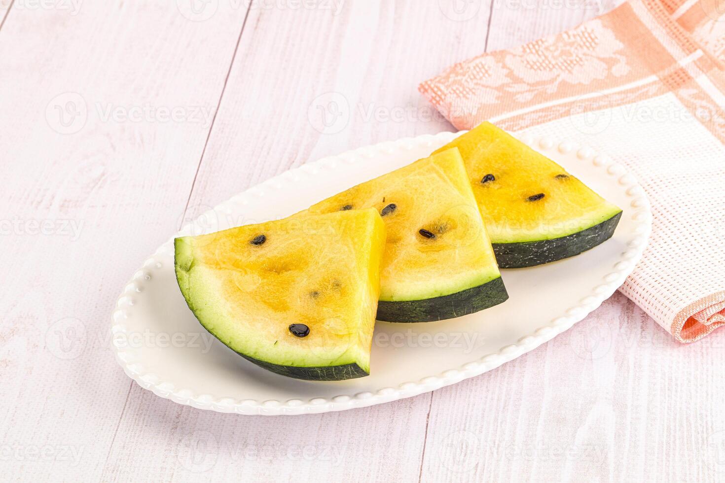 A white plate with slices of watermelon on it photo