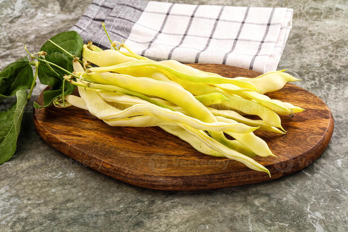 A bunch of beans on a wooden cutting board photo