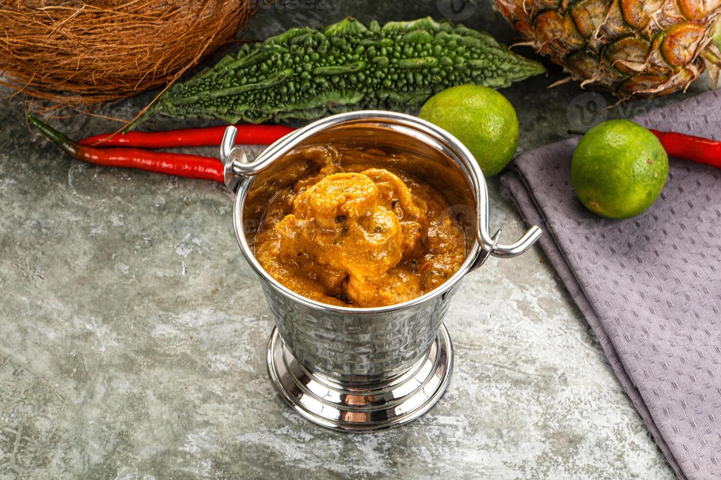 A silver container with a pineapple, lime, and chili photo