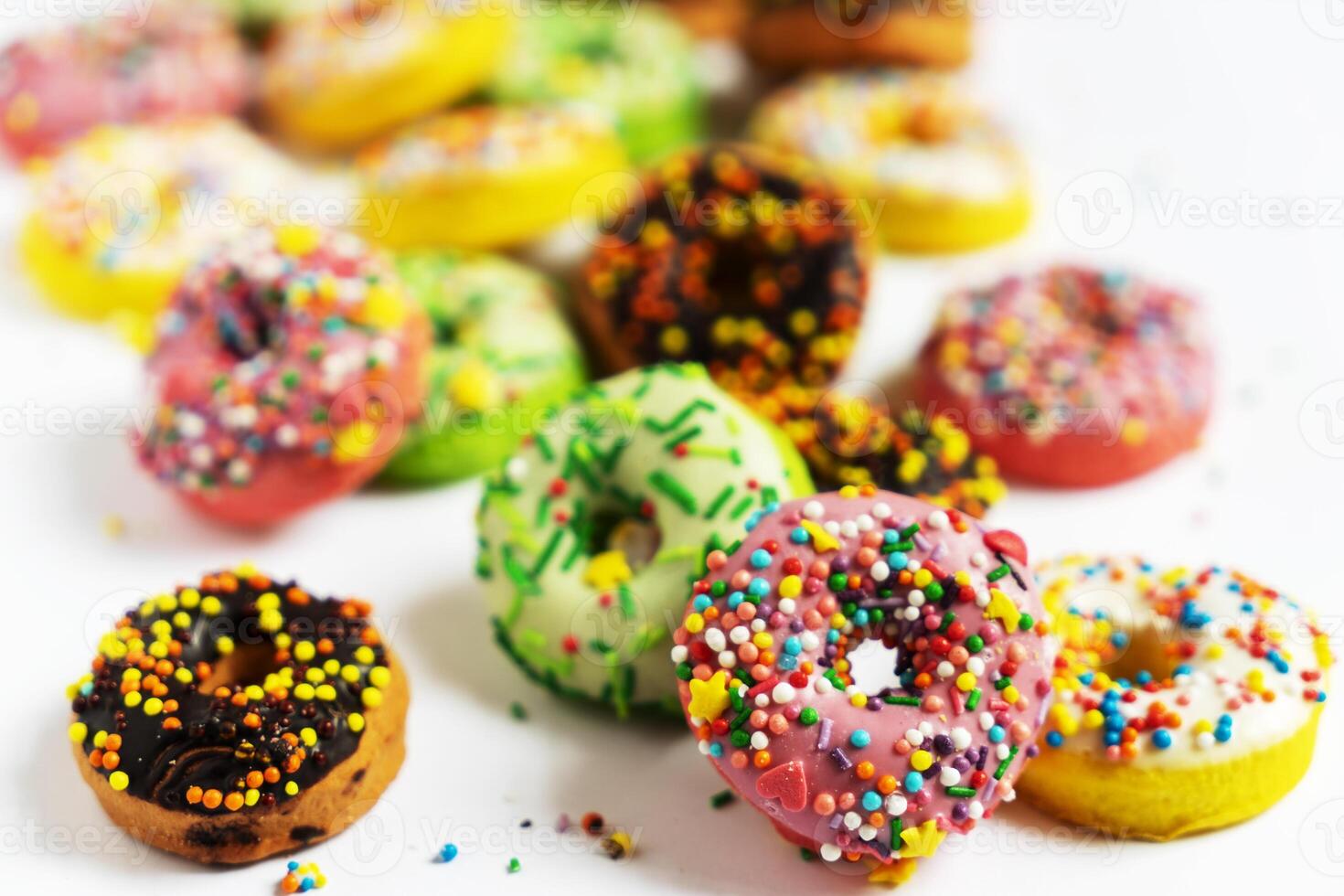 Set of various colorful donuts isolated on white background. Top view. photo