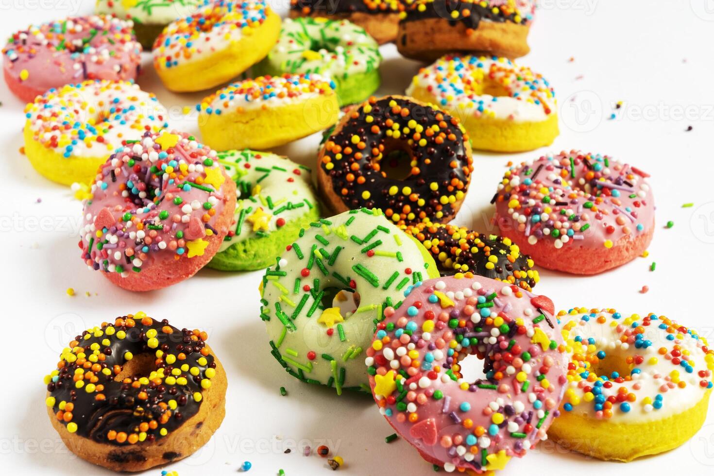 Set of various colorful donuts isolated on white background. Top view. photo