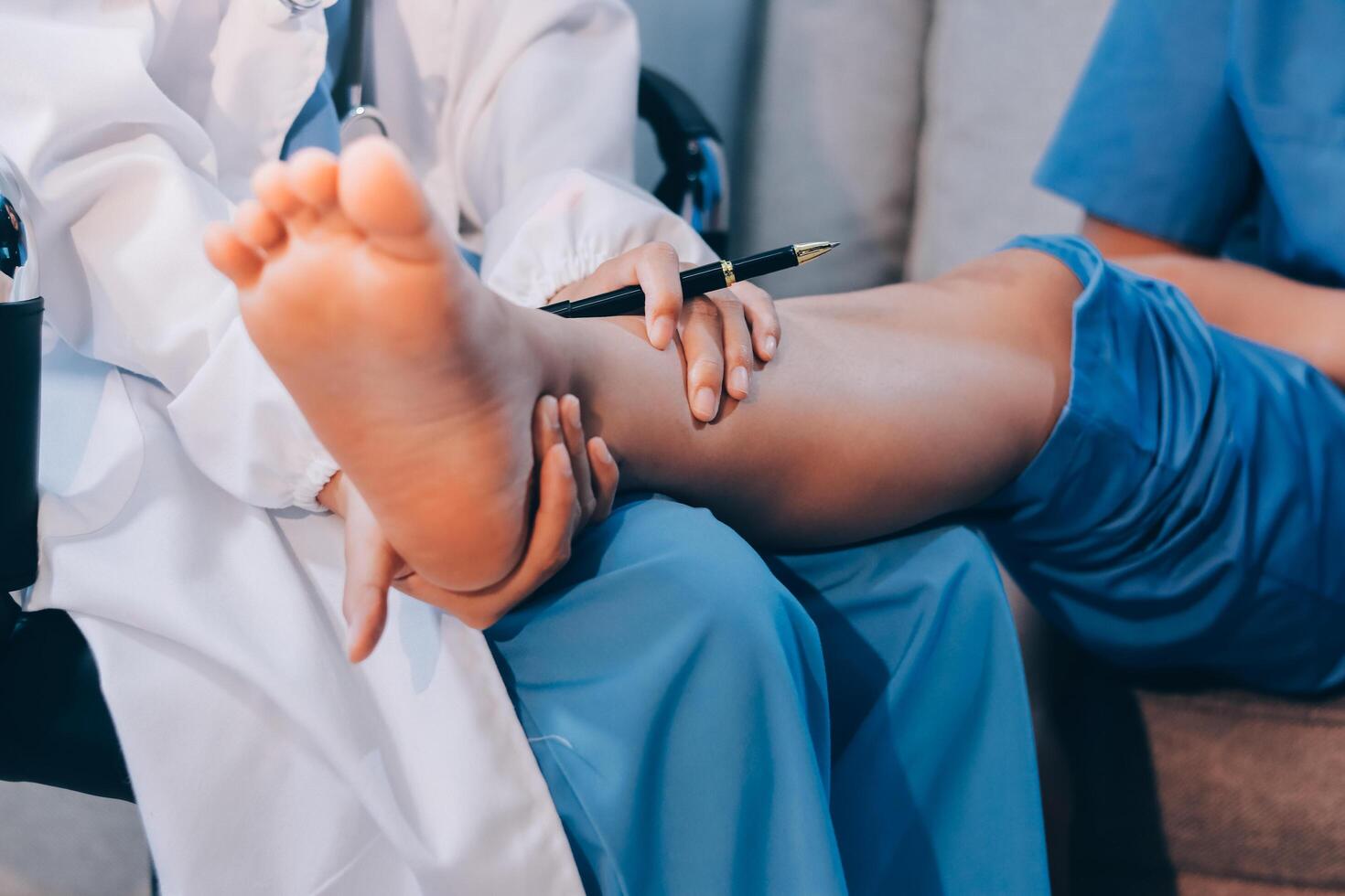 A doctor is examining a patient's foot photo