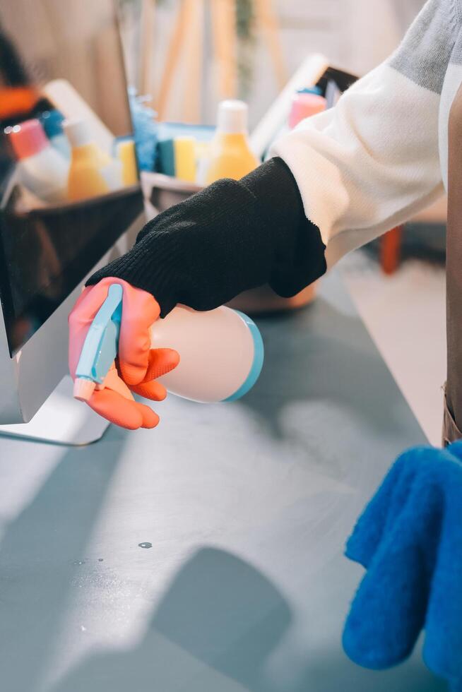 A person is cleaning a computer with a sponge photo