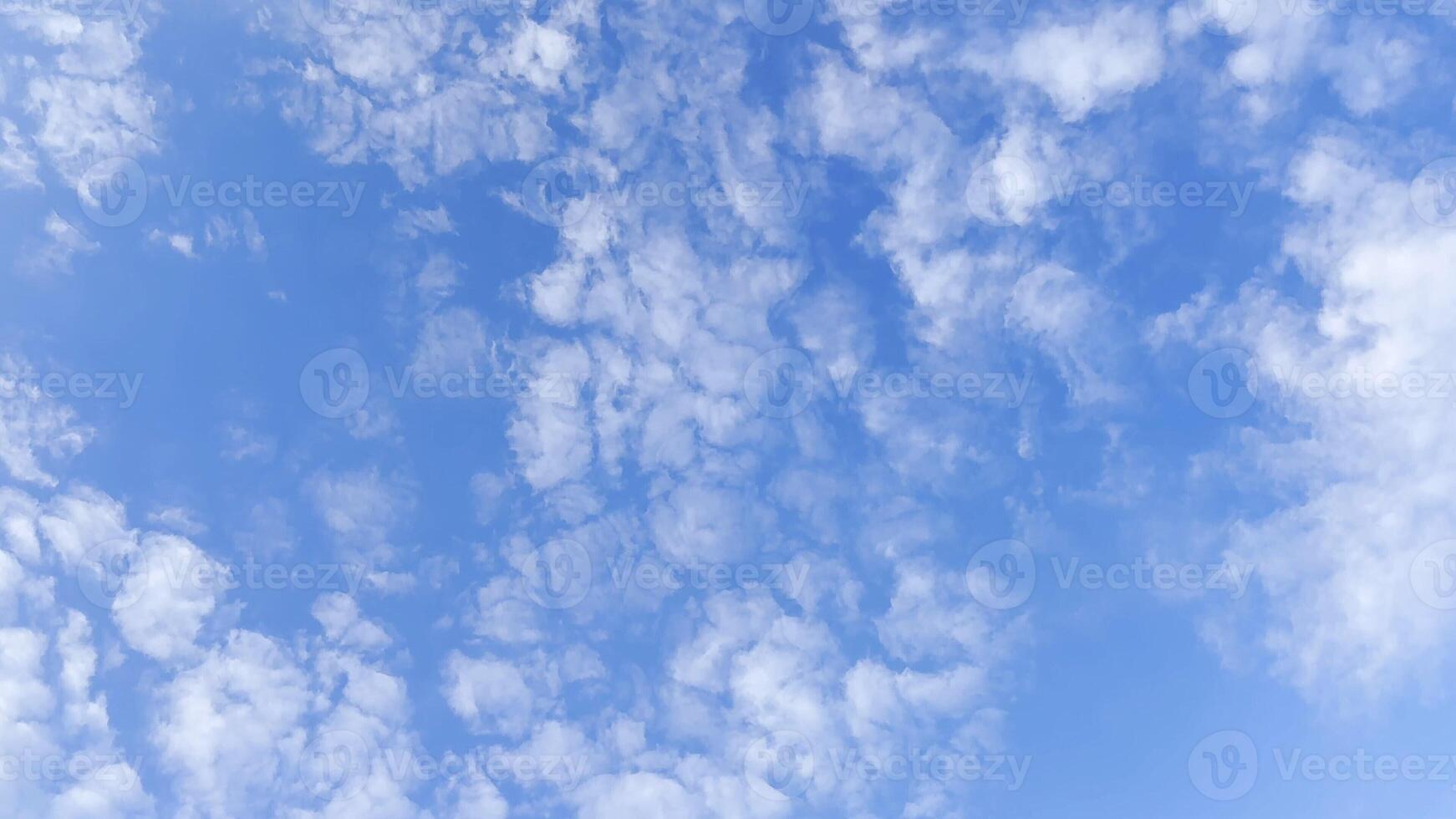 Camera move behind white fluffy clouds on blue sky at summer sunny day. Beautiful nature background. Close up Slow motion photo