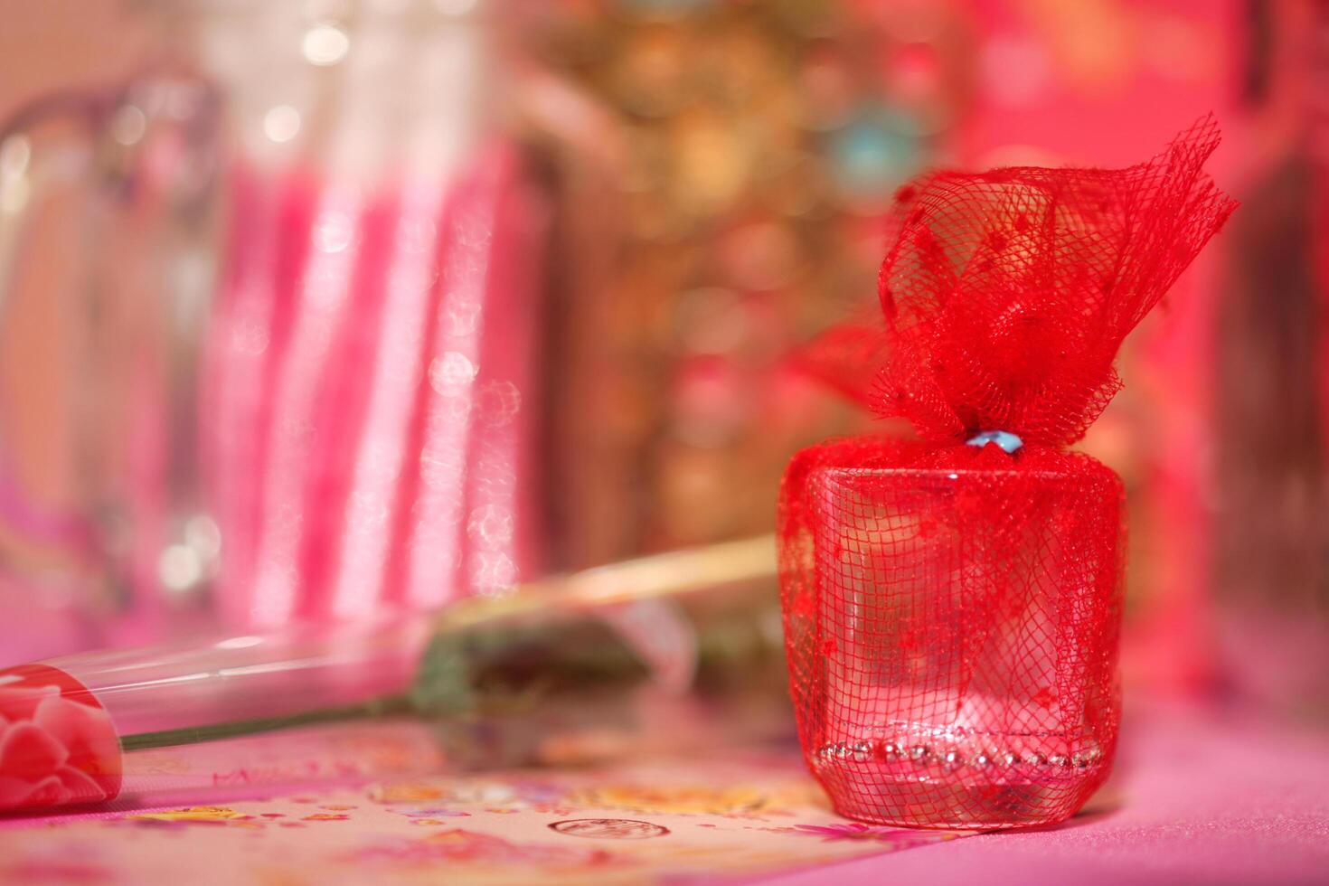 a small vase with a red ribbon tied to it photo