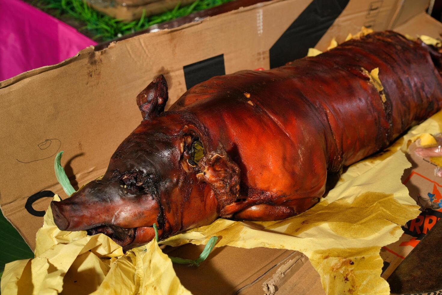 a whole pork lechon is wrapped in a paper photo