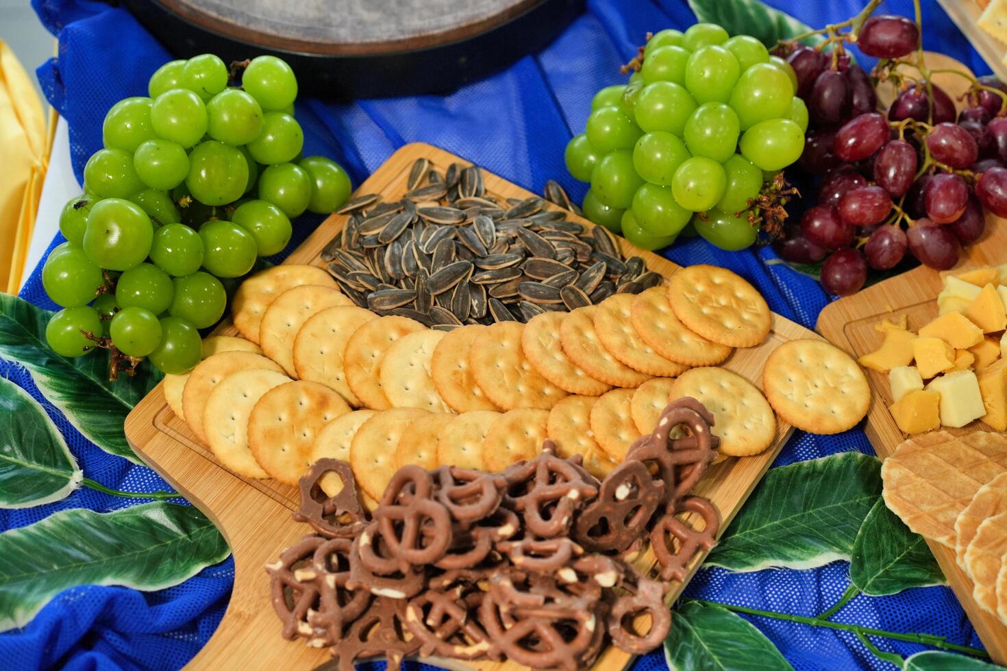 a snacks platter of chocolate covered pretzel, crackers, and sunflower seed photo
