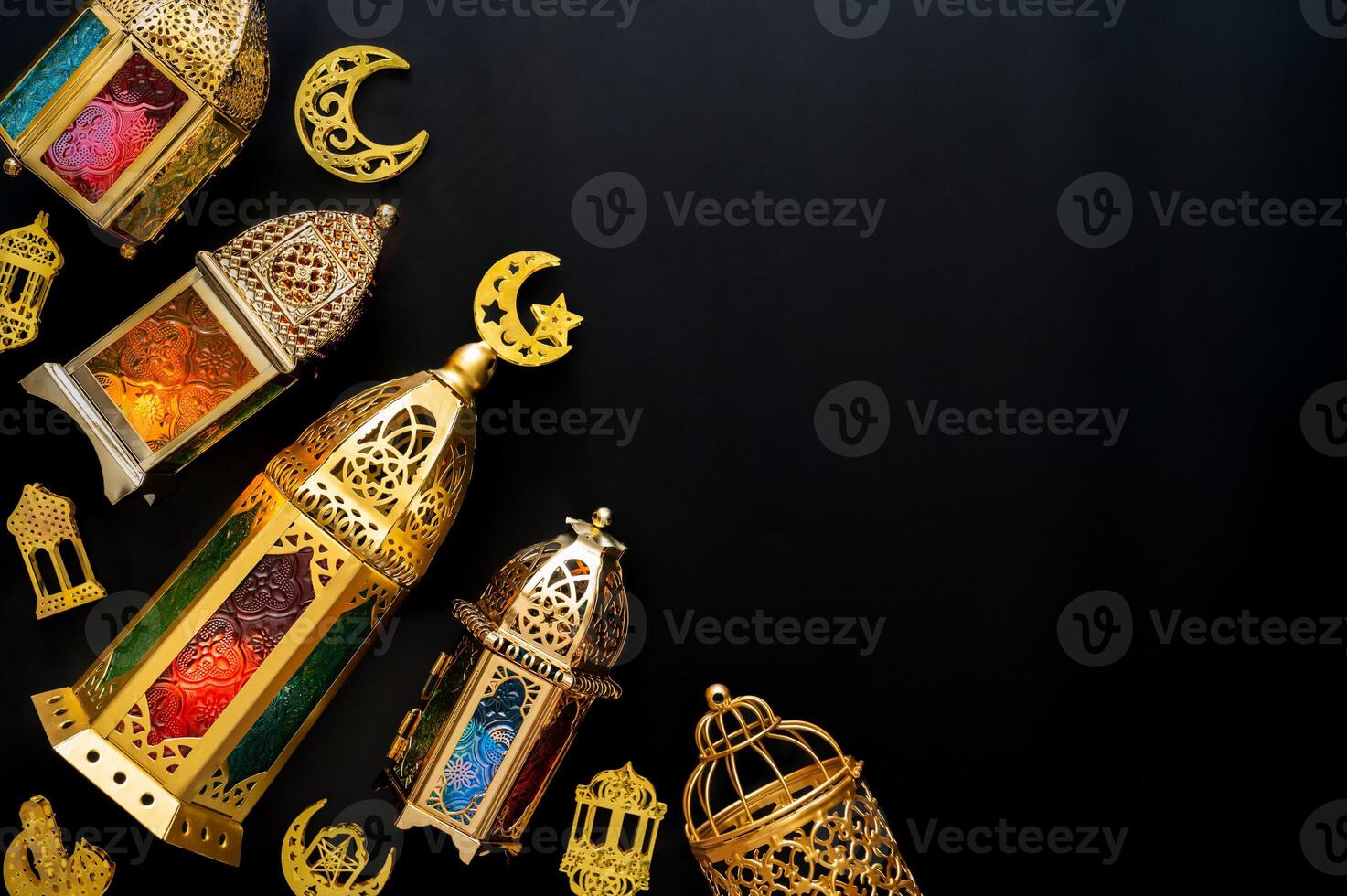 Golden lanterns with light put on black background for the Muslim feast of the holy month of Ramadan Kareem. photo