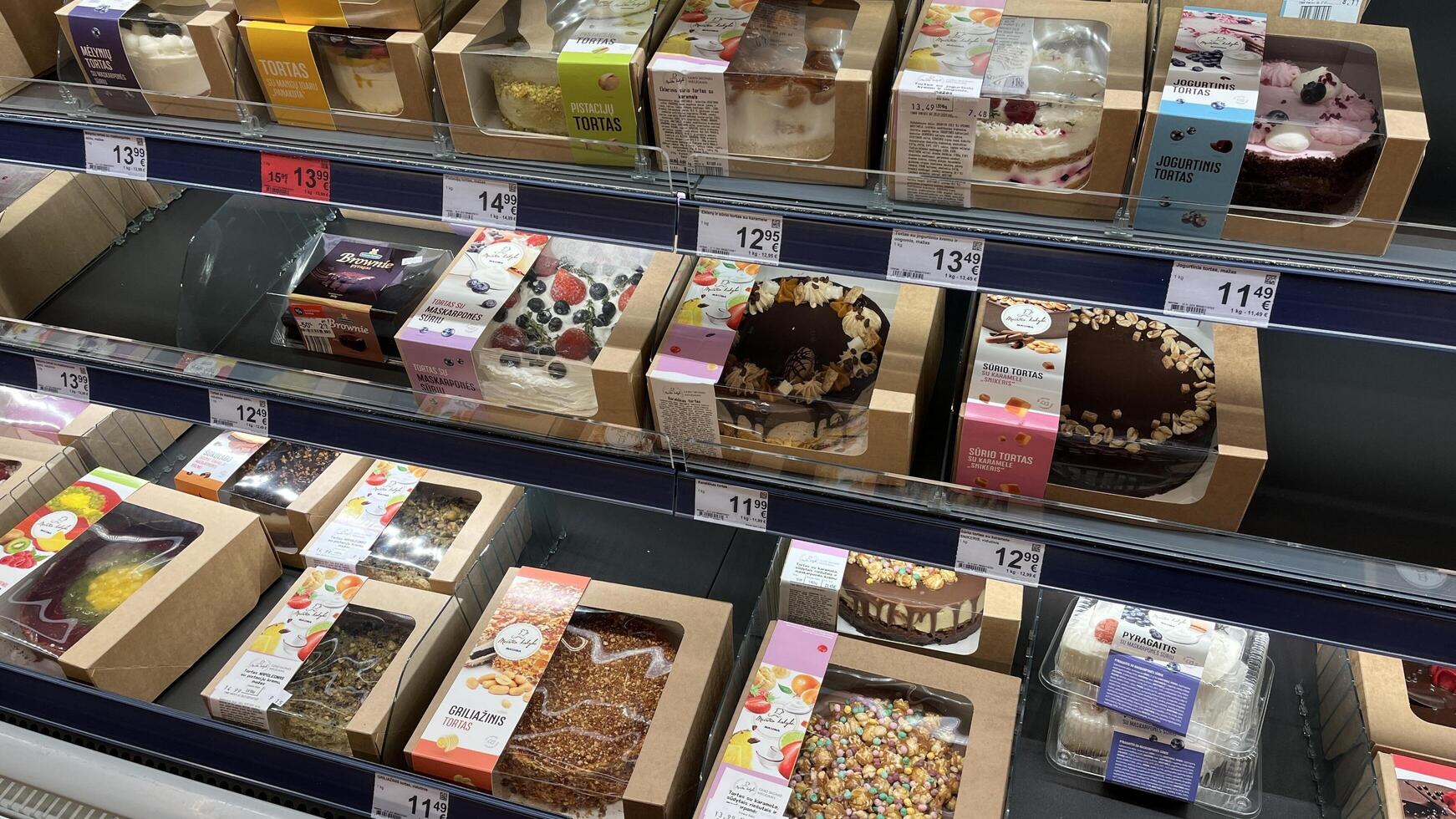 Kaunas, Lithuania. January 24, 2025. A well-stocked refrigerated display case showcases a variety of beautifully packaged cakes and desserts in various sizes and flavors in a grocery store photo