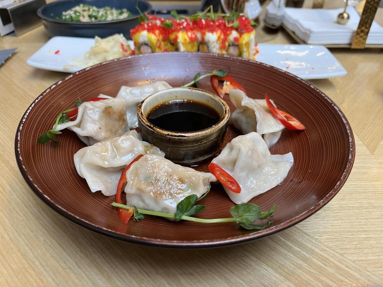 Japanese Gyoza dumplings with beef in a plate on Japanese restaurant table photo
