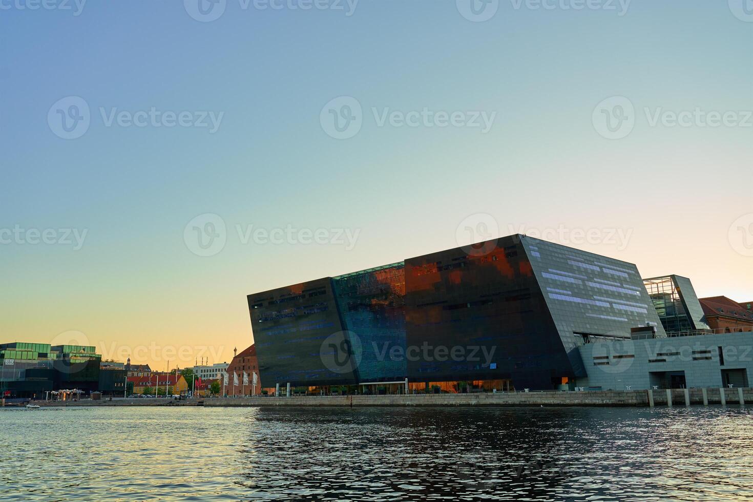 Exterior of Royal Library in Copenhagen. Facade of national library of Denmark known as the Black Diamond at sunset. Modern architecture in city photo