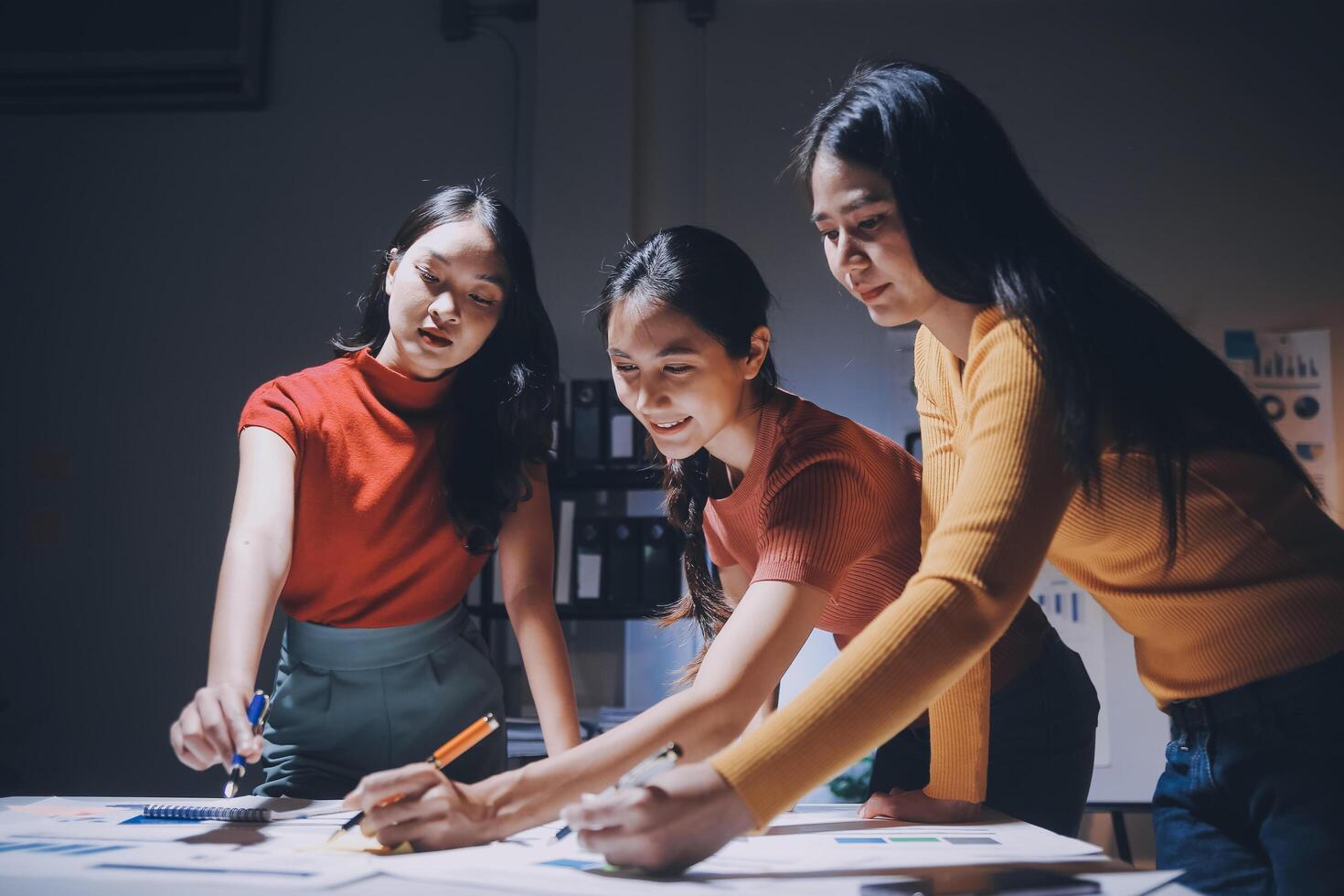 Three women working on a project together photo