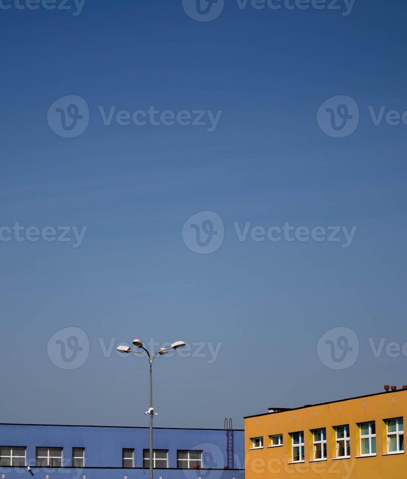 Colors of urban buildings under a clear blue sky in bright daylight photo