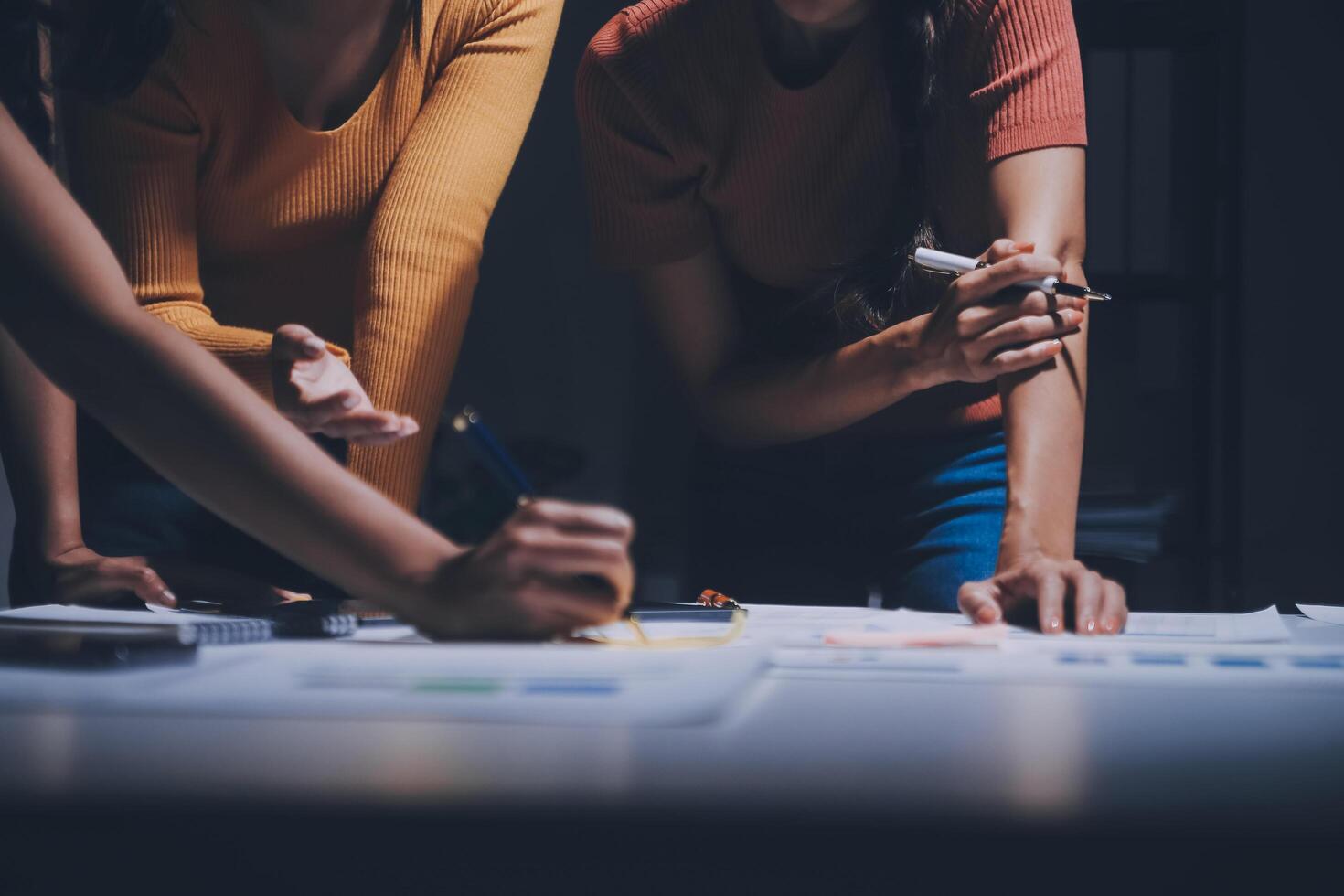 Three people working on a project at a table photo