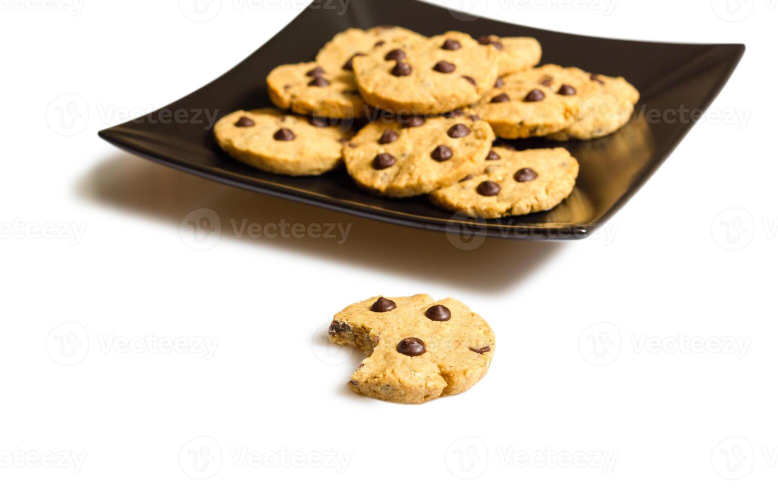 Chocolate chip cookies on a black plate composition photo