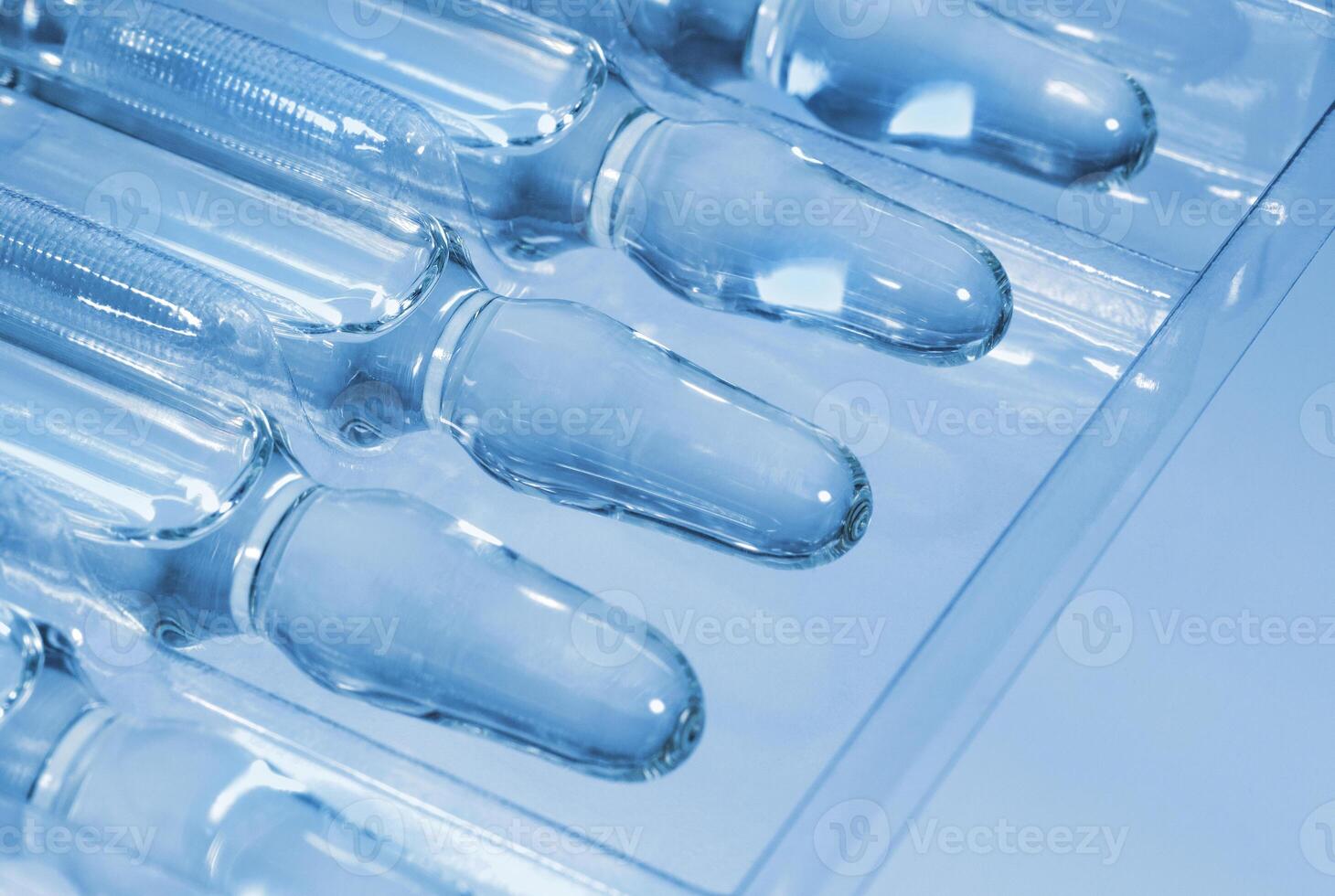 Medical ampoules on the plastic tray close up photo