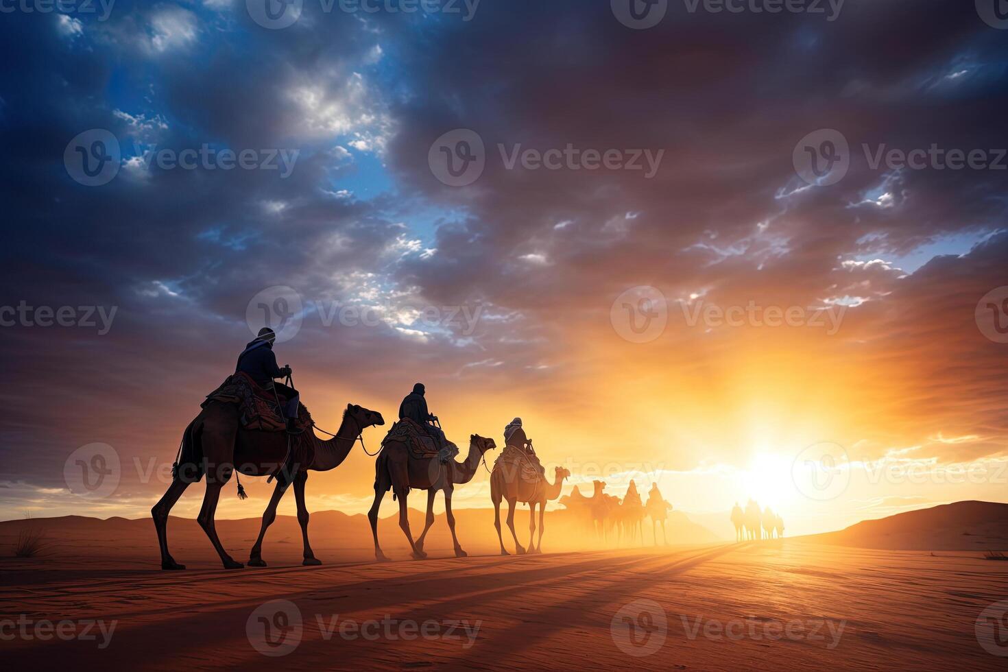 A group of people riding camels in the desert at sunset photo