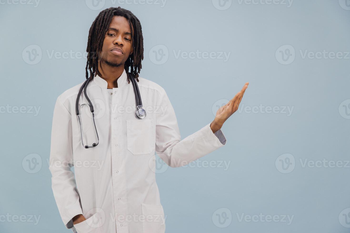 Young African American Doctor Showing Something on Light Blue Background photo