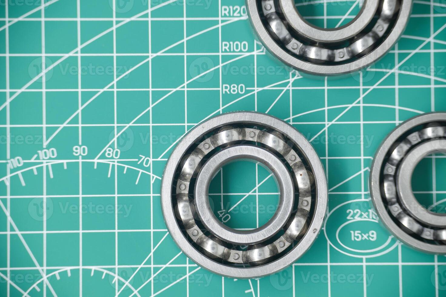 Close-Up of Ball Bearings on a Gridded Measurement Mat Surface photo