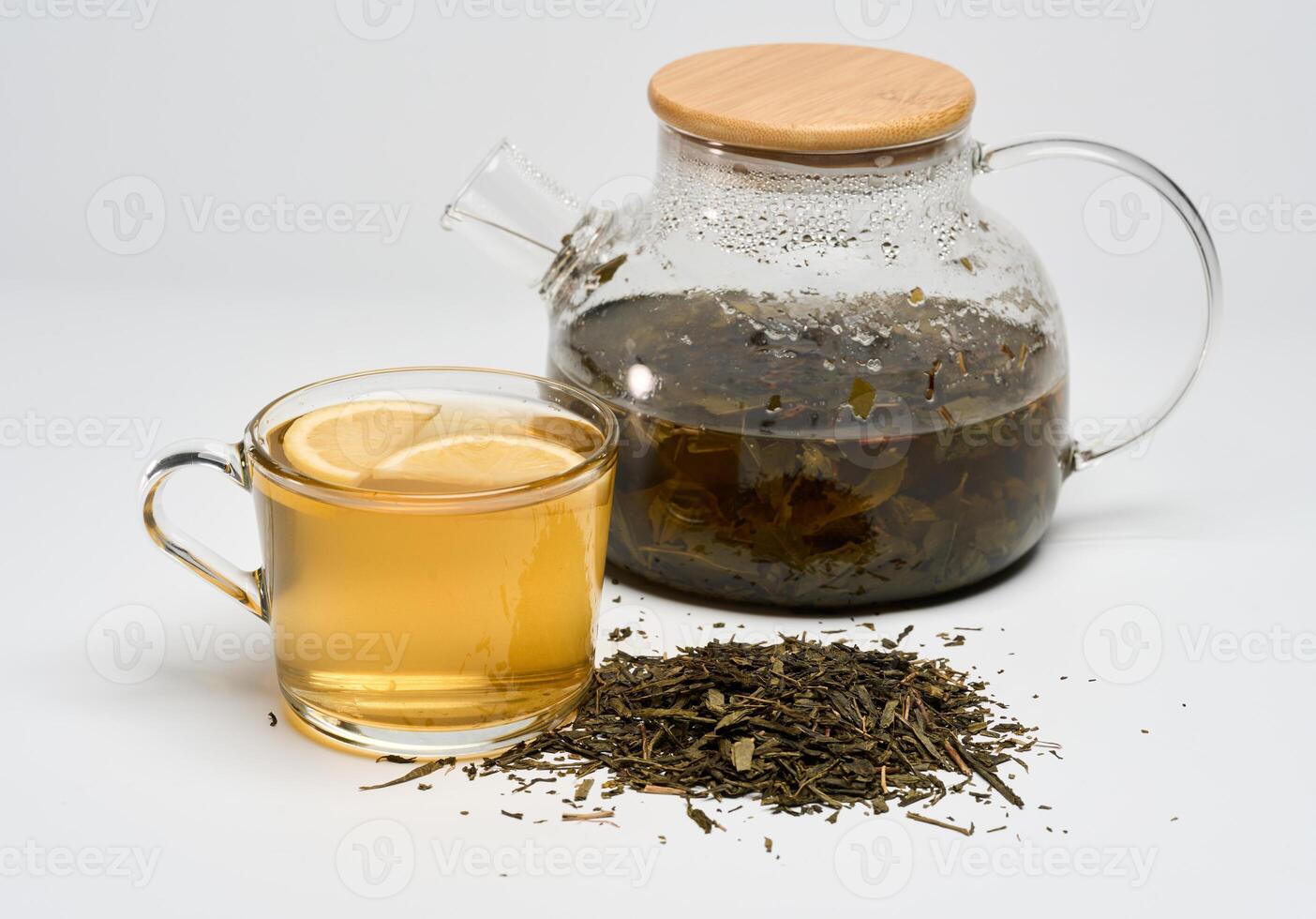 Green tea with lemon and leaves photo