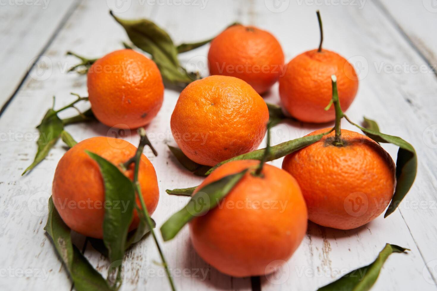 A group of oranges on a wooden table photo