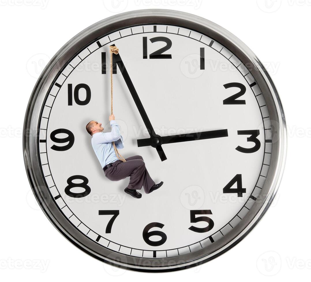 A man hanging from a clock with a rope photo
