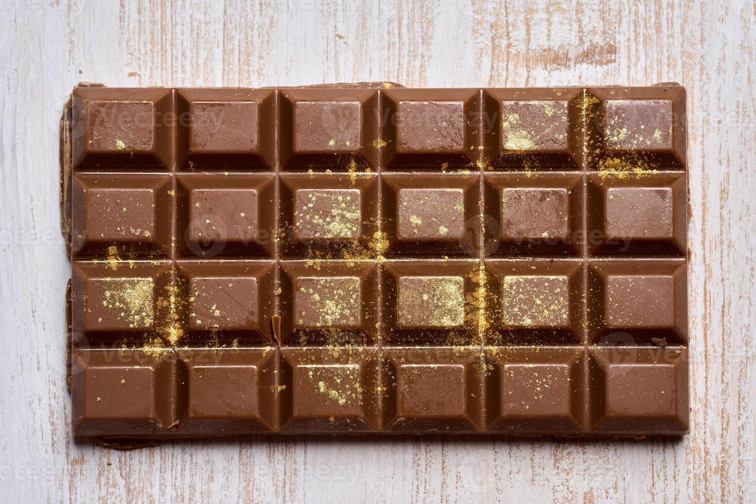 A piece of chocolate with gold flakes on it photo