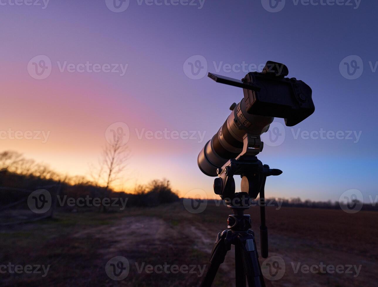 A tripod with a camera on it photo